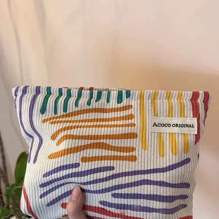 Pochette cosmétique en velours côtelé à rayures colorées