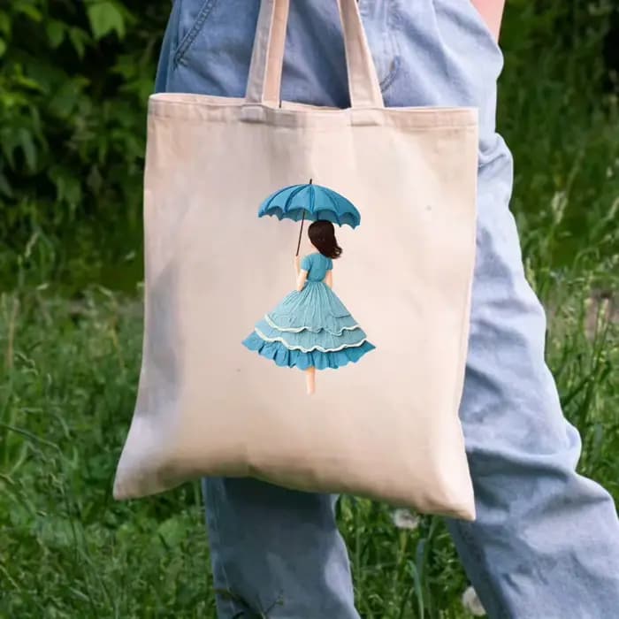 Sac fourre-tout en toile beige avec un imprimé féminin d'un parapluie et une robe bleue